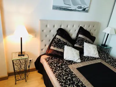 a bedroom with a bed with black and white pillows at Ô Palais des Iles Two Bedroom Cannes in Cannes