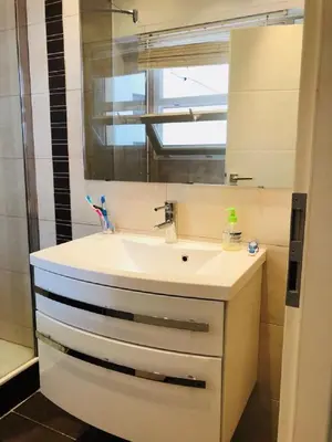 a bathroom with a sink and a mirror at Ô Palais des Iles Two Bedroom Cannes in Cannes