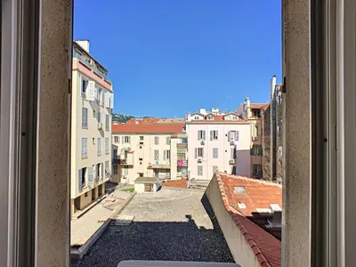 a view from a window of a street with buildings at Studio Vagliano in Cannes