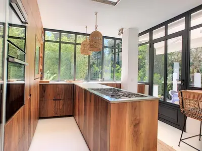 a kitchen with wooden cabinets and a counter top at Villa Riviera in Cannes