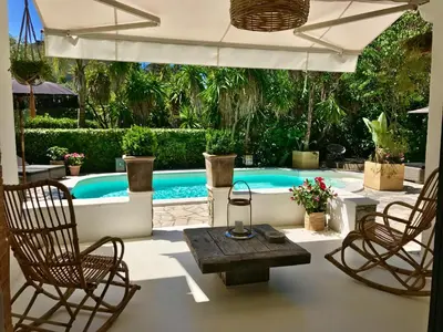 a swimming pool with two chairs and a table at Villa Riviera in Cannes