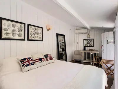 a bedroom with a white bed with two pillows on it at Villa Riviera in Cannes