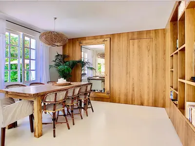a dining room with a wooden table and chairs at Villa Riviera in Cannes