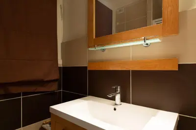 a bathroom with a white sink and a mirror at 2-Br Apartment 2 min from the Beaches in Cannes