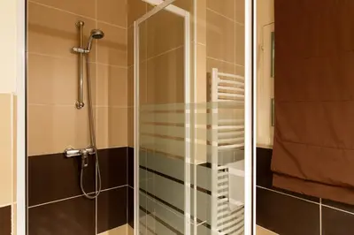 two pictures of a shower with a glass door at 2-Br Apartment 2 min from the Beaches in Cannes