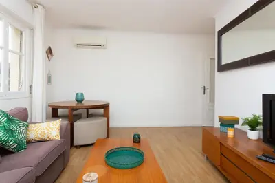 a living room with a couch and a table at 2-Br Apartment 2 min from the Beaches in Cannes