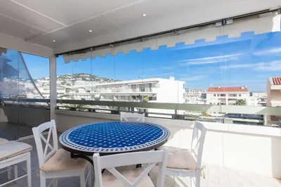a table and chairs on a balcony with a view at High-Standard 2-Bedroom Apartment with Sea View and Large Terrace in Cannes