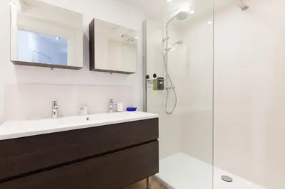 a bathroom with a sink and a shower at High-Standard 2-Bedroom Apartment with Sea View and Large Terrace in Cannes