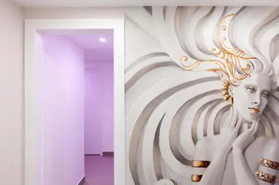 a painting of a woman on a wall at 2-Br apartment 2 minutes from the beach parking in Cannes
