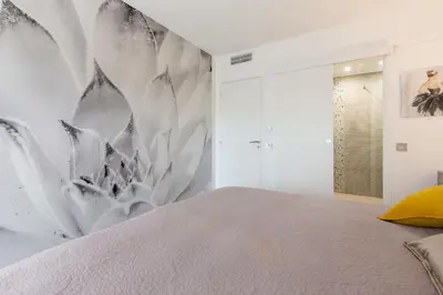 a bedroom with a bed and a wall mural at 2-Br apartment 2 minutes from the beach parking in Cannes