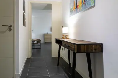 a hallway with a desk in a room at 2-Br with Garden and Pool in the Heart of Palm Beach in Cannes