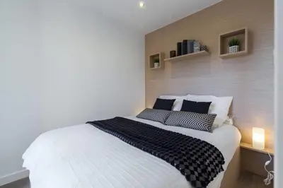 a bedroom with a large white bed with two pillows at Haven of Peace 1-Br Terrace with Sea View & Pool in Cannes
