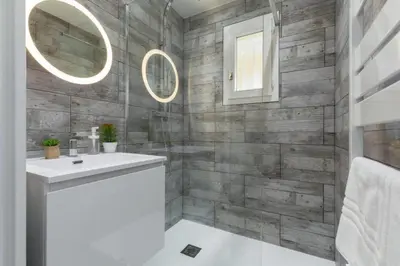 a bathroom with a sink and a mirror at Haven of Peace 1-Br Terrace with Sea View & Pool in Cannes