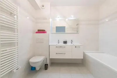 a bathroom with a toilet and a sink and a tub at Renovated 2-Br Apartment with Terrace and Pool in Cannes