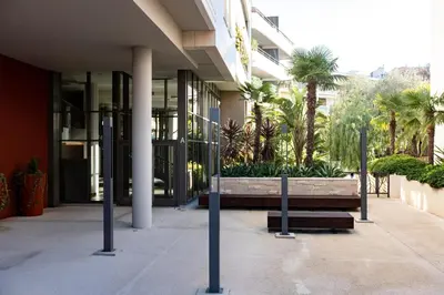 a building with a bench in front of a building at Renovated 2-Br Apartment with Terrace and Pool in Cannes