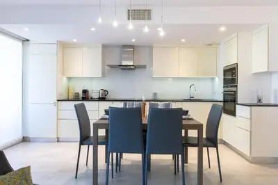 a kitchen with a dining room table and chairs at Renovated 2-Br Apartment with Terrace and Pool in Cannes