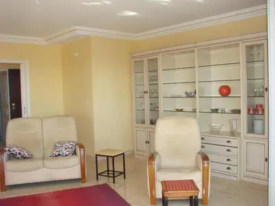 a living room with two chairs and a dresser at The Best Place in Cannes