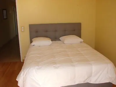 a large white bed with two pillows on it at The Best Place in Cannes
