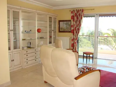 a living room with white furniture and a large window at The Best Place in Cannes