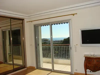 a room with a sliding glass door with a balcony at The Best Place in Cannes