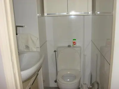 a bathroom with a white toilet and a sink at The Best Place in Cannes