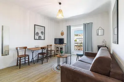 a living room with a couch and a table at Joli appartement à côté du Palais des Festivals in Cannes