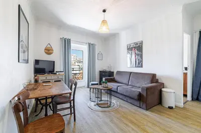 a living room with a couch and a table at Joli appartement à côté du Palais des Festivals in Cannes