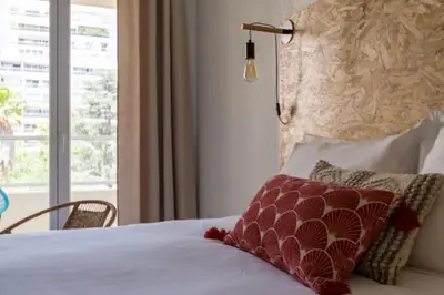 a hotel room with a bed with a window at Appartement Palais Milton in Cannes