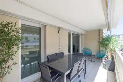 a balcony with a table and chairs on it at Appartement Palais Milton in Cannes