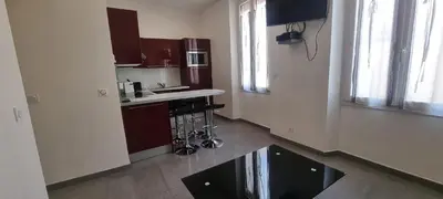 a kitchen with a sink and a counter in a room at One Bedroom André in Cannes