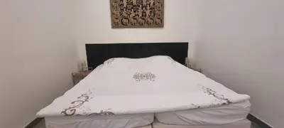 a bed in a room with a white blanket at One Bedroom André in Cannes
