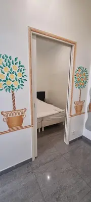 a room with a mirror and a bedroom with a bed at One Bedroom André in Cannes