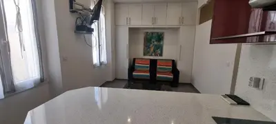 a kitchen with a table and a chair in a room at One Bedroom André in Cannes