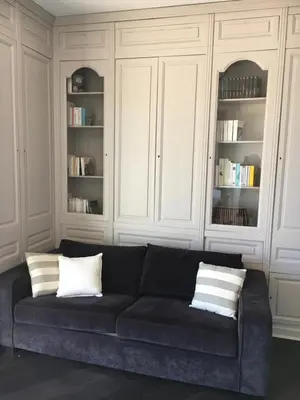 a black couch with two pillows in a living room at Appartement Le Palais Des Iles in Cannes