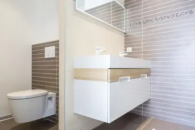 a bathroom with a white toilet and a sink at PLAGE Ground floor apartment on seafront with large terrace in Cannes