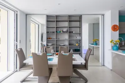 a dining room with a table and chairs at PLAGE Ground floor apartment on seafront with large terrace in Cannes