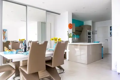 a dining room with a table and chairs at PLAGE Ground floor apartment on seafront with large terrace in Cannes