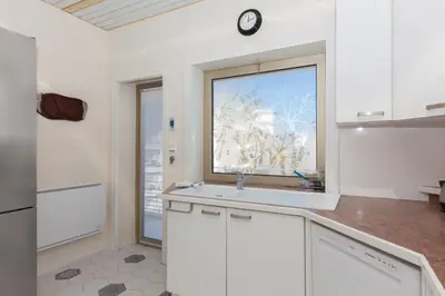 a white kitchen with a sink and a window at Sea View Cannes Croisette in Front of the Sea in Cannes