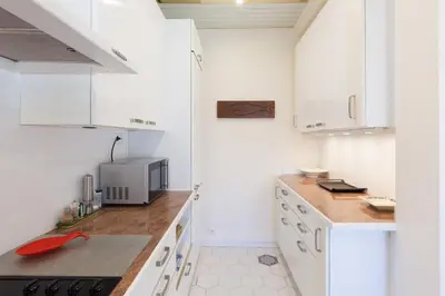 a kitchen with white cabinets and a counter top at Sea View Cannes Croisette in Front of the Sea in Cannes