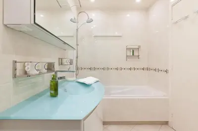 a bathroom with a blue sink and a tub at Sea View Cannes Croisette in Front of the Sea in Cannes