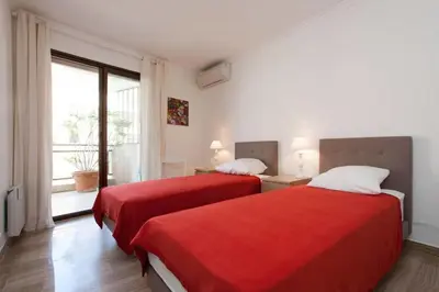 two beds in a room with a window at 3-Room Apartment with Terrace in Palm Beach in Cannes