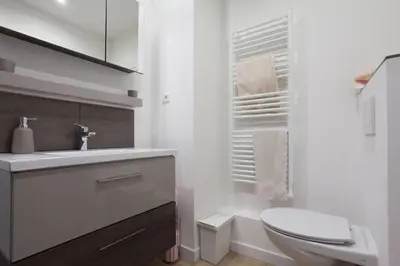 a white bathroom with a toilet and a sink at 3-Room Apartment with Terrace in Palm Beach in Cannes