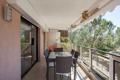 a balcony with a table and chairs on a balcony at 3-Room Apartment with Terrace in Palm Beach in Cannes