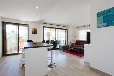 a kitchen and living room with a bar in a house at 3-Room Apartment with Terrace in Palm Beach in Cannes