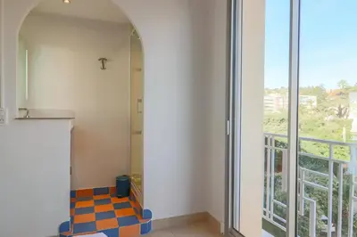a bathroom with a tile floor and a window at Superb Bright Apartment with Sea View in Cannes