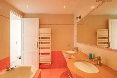 a bathroom with two sinks and a mirror at Superb Bright Apartment with Sea View in Cannes