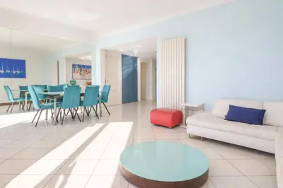 a living room with a couch and a table at Superb Bright Apartment with Sea View in Cannes