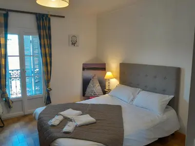 a bedroom with a bed with two towels on it at Stella Apartment - Cannes in Cannes