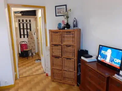 a living room with a television and a room with a door at Stella Apartment - Cannes in Cannes