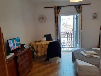 a room with a bedroom with a table and a television at Stella Apartment - Cannes in Cannes